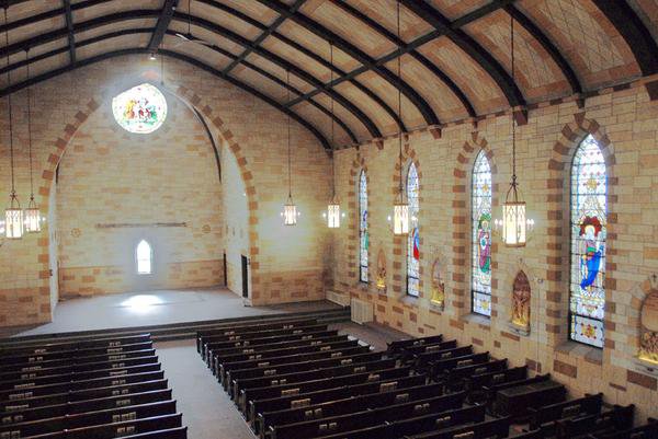 St. Ireneaus Catholic Church sanctuary before restoration, with no altars