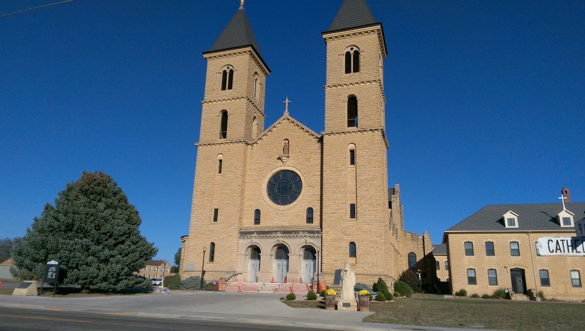 Twin limestone towers of St. Fidelis Church, the Cathedral of the Plains, in Victoria, Kansas