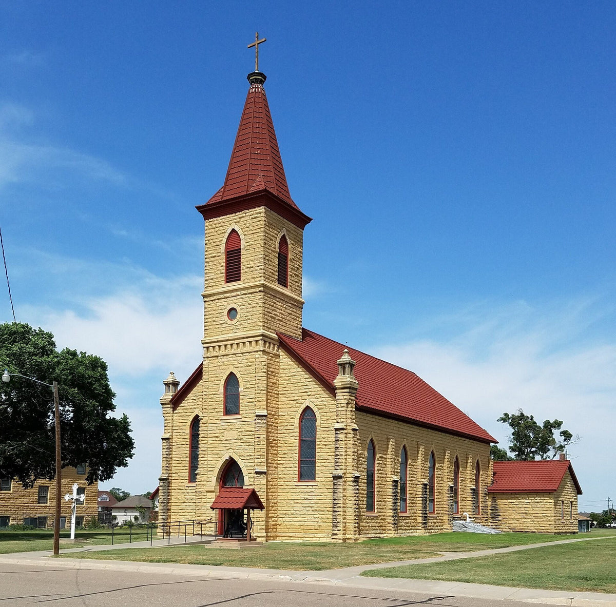 St. Anthony Church in Schoenchen, Kansas, built of fencepost limestone with a red steeple